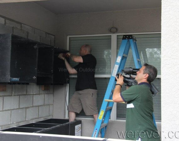 outdoor wall cabinets being installed