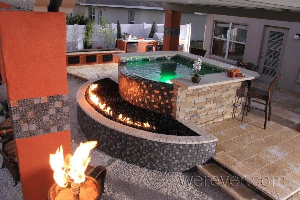 infinity edge bar with firepit and outdoor kitchen